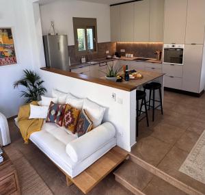a living room with a couch and a kitchen at Villa Paradisio in EFL