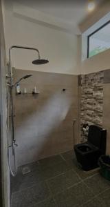 ein Badezimmer mit Dusche und schwarzer Toilette in der Unterkunft Villa Amber Breeze in Mirissa + 11 Fotos