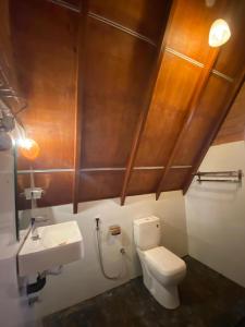 a bathroom with a toilet and a sink at Green Forrest Cabanas - Ella in Ella