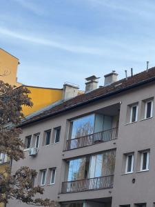 an apartment building with balconies on the side of it at SaraRose in Sarajevo