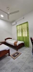 Ένα ή περισσότερα κρεβάτια σε δωμάτιο στο Sofea Rania Homestay