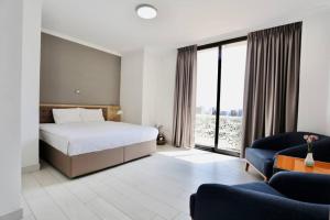 Ένα ή περισσότερα κρεβάτια σε δωμάτιο στο Le Basilic Hotel Apartment & Spa