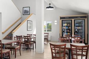 a restaurant with tables and chairs and a staircase at Days Inn by Wyndham Las Vegas in Las Vegas