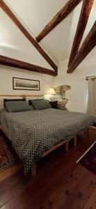 a bedroom with a bed in a room with wooden beams at Dolomites Luxury Penthouse in Agordo