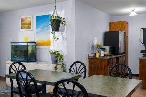 a dining room with two tables and a fish tank at Days Inn by Wyndham Jamestown in Jamestown