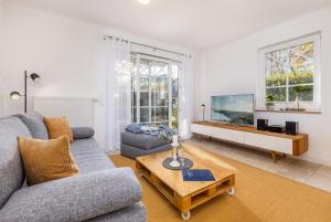 a living room with a couch and a table at Whg Dynamique in Zingst +19 photos