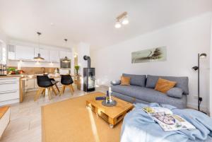 a living room with a couch and a table at Whg Dynamique in Zingst
