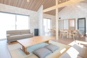 a living room with a couch and a table at HIGASHIKAWA Villa 瑞月 in Higashikawa +89 photos
