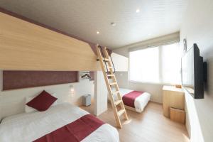a bedroom with a bunk bed and a ladder at HIGASHIKAWA Villa 瑞月 in Higashikawa