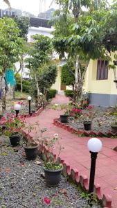un jardín con macetas y una pasarela de ladrillo en Wild Forest Inn Thekkady, en Thekkady 5 fotos más