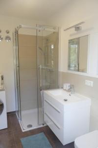 a white bathroom with a shower and a sink at Apartment in Stetten bei Mindelheim in Stetten +8 photos
