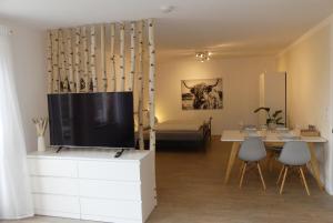 a living room with a flat screen tv on a cabinet at Apartment in Stetten bei Mindelheim in Stetten