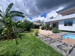 a backyard with a swimming pool and a house at villa liam kiwengwa zanzibar in Kiwengwa