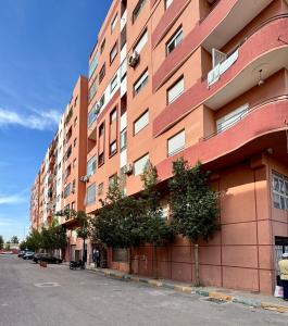 a tall building with trees on the side of it at Dana in Beni Mellal
