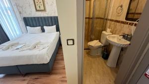 a bedroom with a bed with a sink and a toilet at Hotel Tulip House in Istanbul