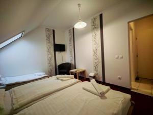 a bedroom with a large bed in a room at Menta Rooms & Bar in Kapuvár +42 photos