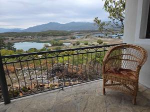 a wicker chair sitting on a balcony with a view at Lakeside View in Kuside