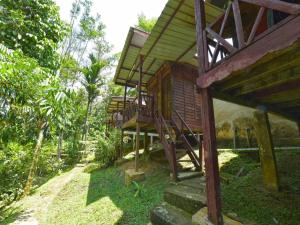 a wooden house with a staircase in a forest at OYO 90630 Mat Leon Village in Kuala Tahan +60 photos
