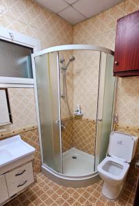 a bathroom with a shower and a toilet at Elegant Private Rooms in a Penthouse with Free Parking in Sharjah