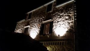 a building with lights on the side of it at night at Buena Vis-ta Apartments with the Sea View in Vis