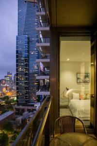 a balcony with a view of a city at night at Balcony, Free Parking, Workspace, Shared Pool & Gym in Melbourne