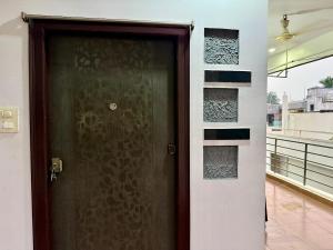 a brown door in a room with a balcony at Vididhi By N - 2BHK Neo Stay in Kottapeta