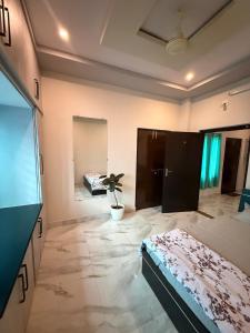 a room with a bed and a potted plant in it at Vididhi By N - 2BHK Neo Stay in Kottapeta +12 photos
