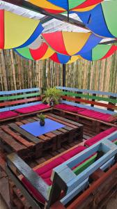 a group of picnic tables with an umbrella at Tuaran Village Guesthouse in Tuaran