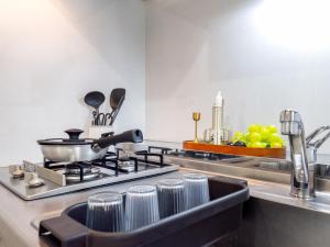 a kitchen with a stove and a sink with dishes at RARE-EBISU BREEZE Apartment in Tokyo