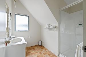 a bathroom with a sink and a shower at Atarau Grove Holiday House in Paraparaumu +22 photos