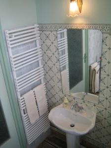 a bathroom with a sink and a mirror at Résidence La Villa Léonie in Nice