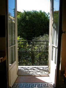 an open door to a balcony with a gate at Résidence La Villa Léonie in Nice