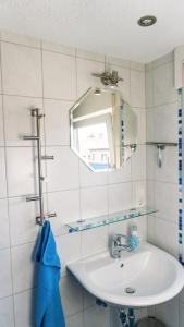 a bathroom with a sink and a mirror at Romantik Ferienhaus 1854 in Elpe +16 photos
