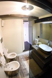 a bathroom with a toilet and a sink at San Francesco Suite in Poggio Bustone