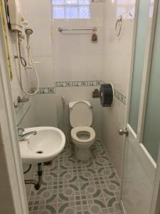 a bathroom with a toilet and a sink at House of Charlie & Ren in Ho Chi Minh City