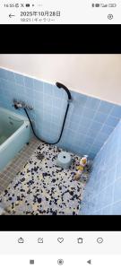 a blue tiled bathroom with a toilet in it at さんこ戸建て1号棟 in Takamatsu