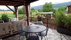 a patio with a table and chairs on a deck at Au Bourg in Le Landeron