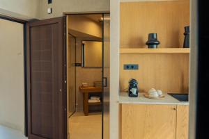 a kitchen with a door open to a room at Beau Rivage Suites in Lóngos +131 photos