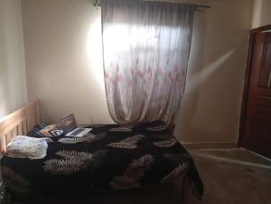 ein Schlafzimmer mit einem Bett und einem Laptop darauf in der Unterkunft Kings Court in Kitengela 