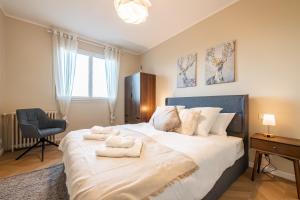 une chambre avec un grand lit avec des serviettes dessus dans l'établissement Chez papa - 3 lits - Confortable & spacieux, à La Ferté-Gaucher