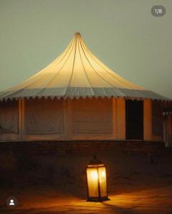 a large white tent with a light in front of it at Heritage Villa Resort Camp in Jaisalmer
