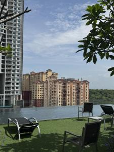 a patio with chairs and a view of a city at Urban Suites Staycation Spot by Twinkle Loft in George Town