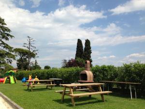 un parc avec deux tables de pique-nique et une aire de jeux dans l'établissement App Bilocale, à Moniga del Garda 22 autres photos