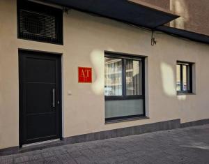 a red exit sign on the side of a building at Apartamentos Picasso by gaiarooms in Salamanca