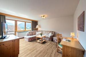 a living room with a couch and a table at Appartementhaus Leitner in Ehrwald