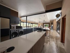 a large kitchen with a large counter top with appliances at Blessed Lodge at Ingilozi Mabalingwe in Warmbaths
