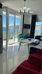 a living room with a table and a view of the ocean at Shengjin apartaments in Lezhë