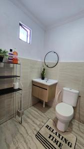 a bathroom with a toilet and a sink at Tuaran Village Guesthouse in Tuaran +24 photos