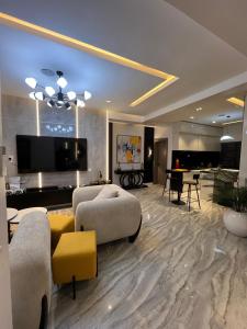 a living room with two couches and a tv at Urban Muse in Lekki