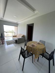 a dining room with a table and chairs and a bedroom at Ap 304 Via Mares do Frances in Marechal Deodoro